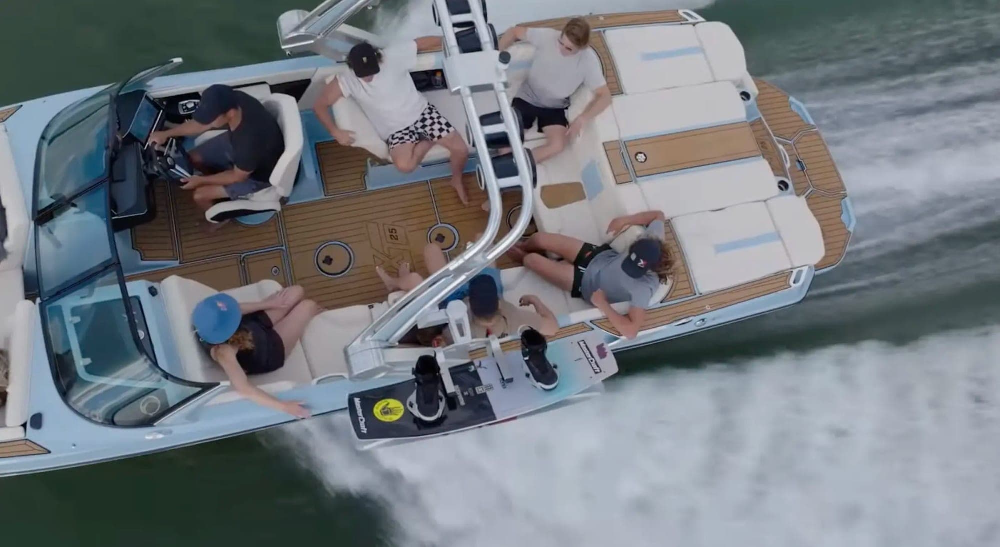 Overhead view of friends aboard a Lake Effects rental boat throwing a wake on Lake Norman